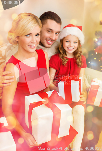 Image of smiling family holding many gift boxes