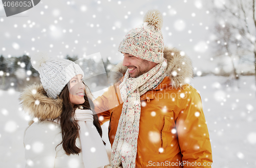 Image of happy couple walking over winter background