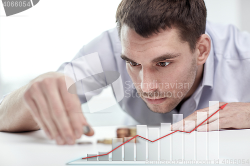 Image of businessman with coins at office