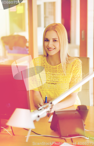 Image of businesswoman with computer and phone at office
