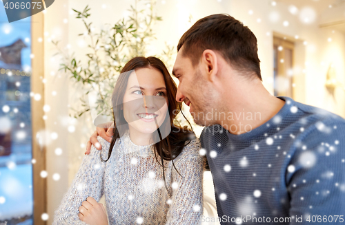 Image of happy couple hugging at cafe or restaurant