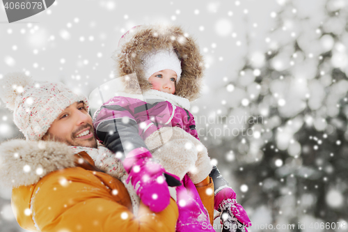Image of happy family in winter clothes outdoors