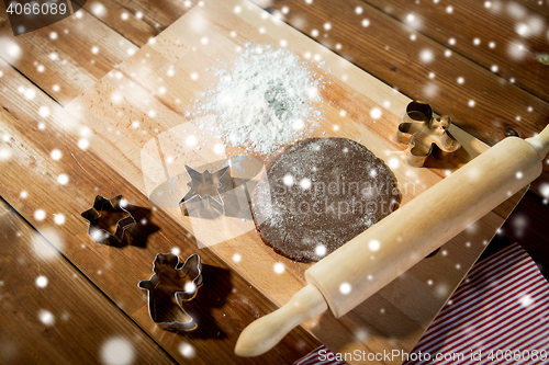 Image of close up of ginger dough, molds and rolling pin