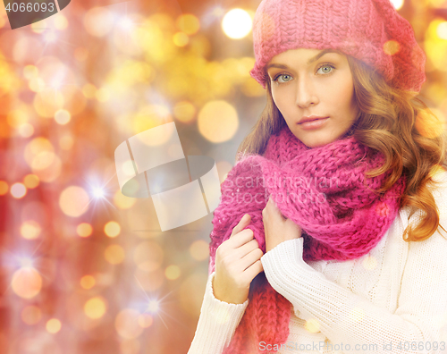 Image of woman in hat and scarf over christmas  lights