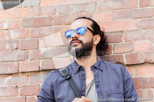 Image of happy man with backpack standing at city street