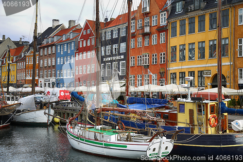 Image of COPENHAGEN, DENMARK - AUGUST 15, 2016: Boats in the docks Nyhavn