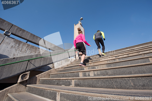 Image of young  couple jogging on steps