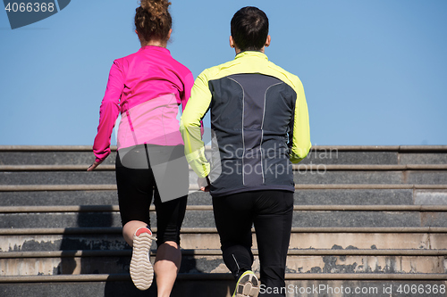 Image of young  couple jogging on steps