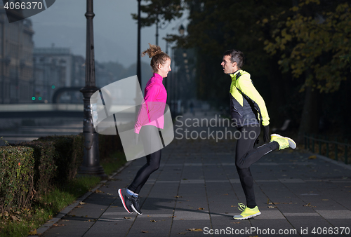 Image of couple warming up before jogging