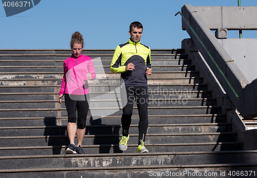Image of young  couple jogging on steps