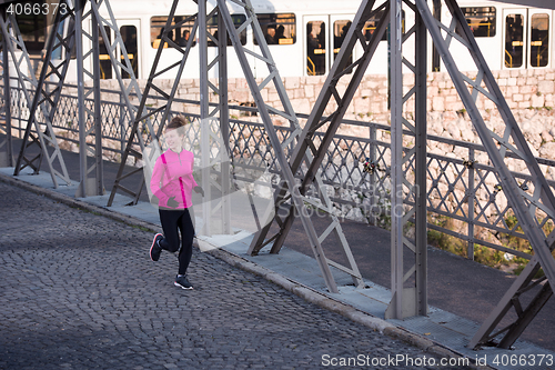 Image of sporty woman jogging on morning