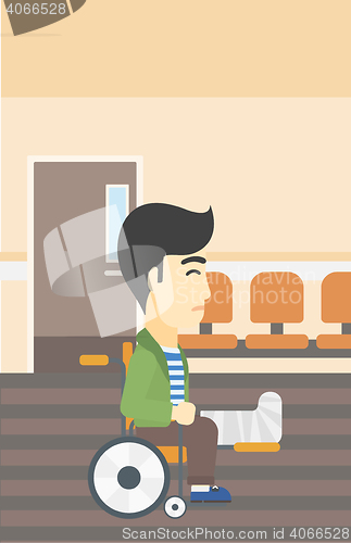 Image of Man with broken leg sitting in wheelchair.