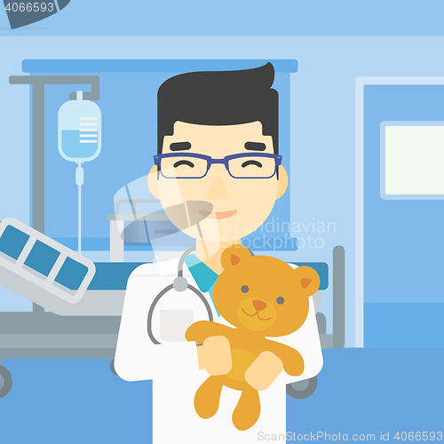 Image of Pediatrician doctor holding teddy bear.