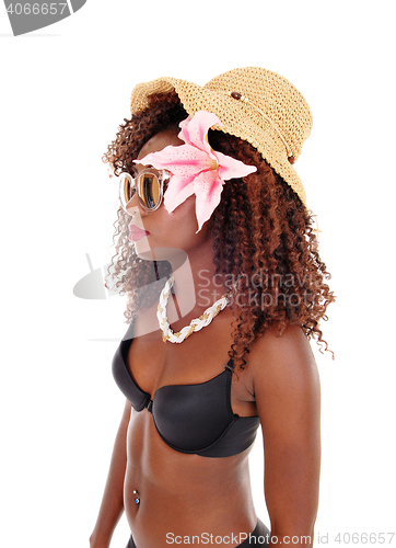 Image of A black woman in bra and straw hat.