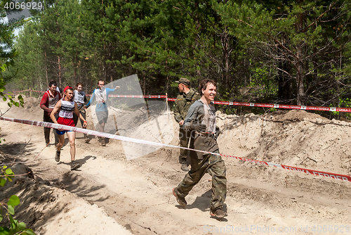 Image of Sportsmen run between stages in extrim race.Tyumen