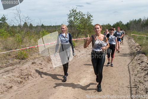 Image of Sportsmen run between stages in extrim race.Tyumen