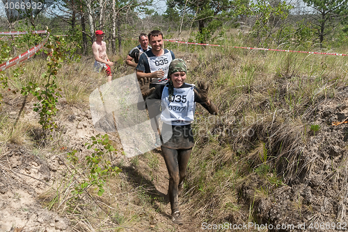 Image of Sportsmen run between stages in extrim race.Tyumen