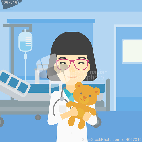 Image of Pediatrician doctor holding teddy bear.