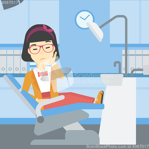 Image of Woman suffering in dental chair.