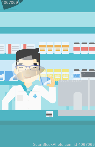 Image of Pharmacist showing some medicine.