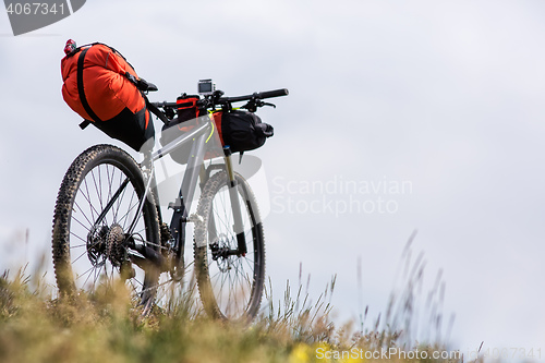 Image of Bicycle with orange bags for travel