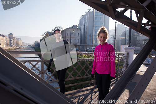 Image of couple warming up before jogging