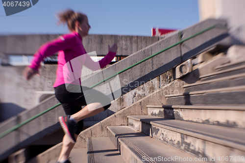 Image of woman jogging on  steps