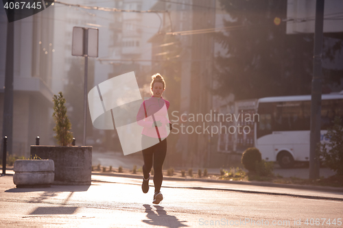 Image of sporty woman jogging on morning