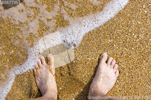 Image of Barefoot on sea surf sand