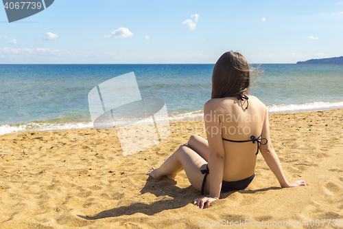 Image of Girl enjoying sun and rest on sea