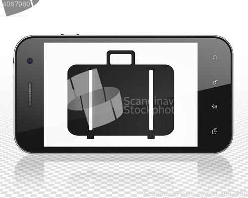 Image of Tourism concept: Smartphone with Bag on display