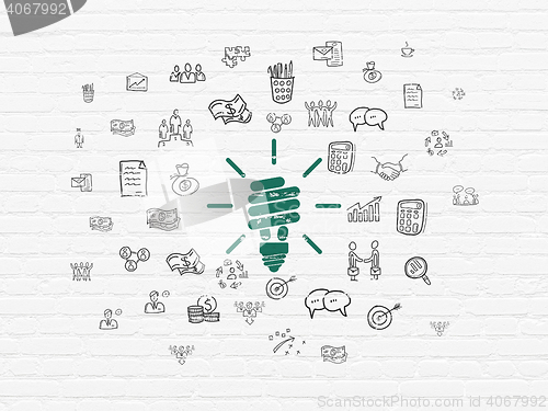 Image of Business concept: Energy Saving Lamp on wall background