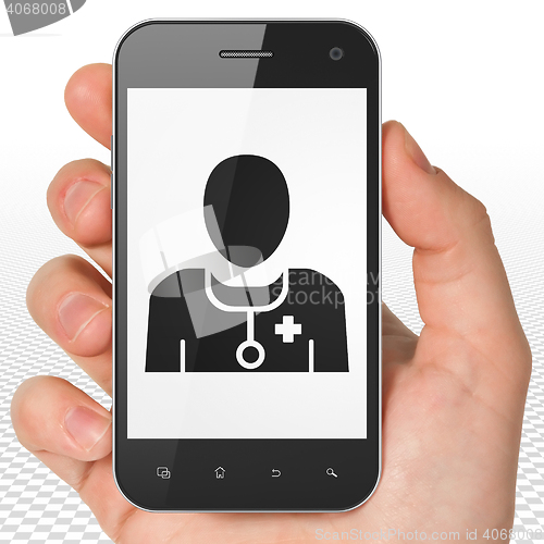 Image of Health concept: Hand Holding Smartphone with Doctor on display