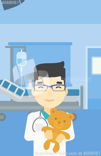 Image of Pediatrician doctor holding teddy bear.