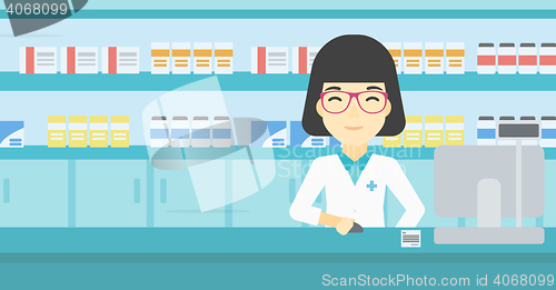 Image of Pharmacist at counter with computer monitor.