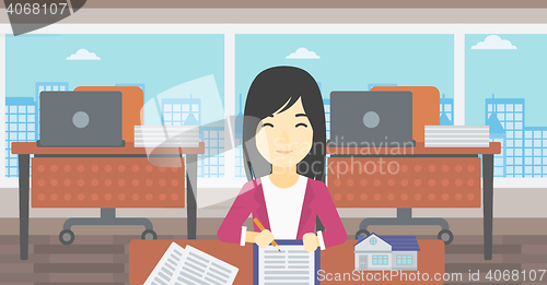 Image of Real estate agent signing contract.