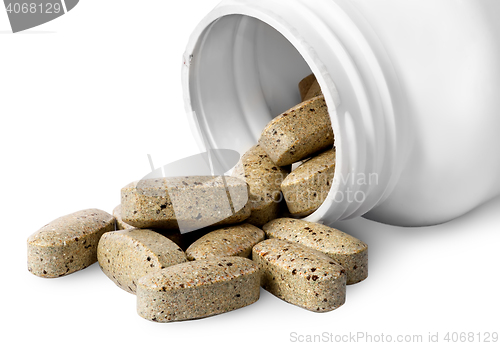 Image of Open plastic bottle and heap of vitamins
