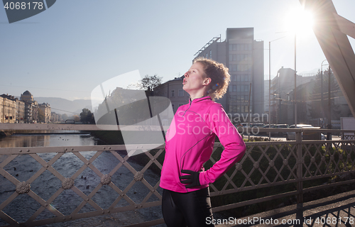 Image of sporty woman jogging on morning