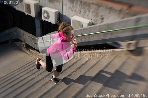 Image of woman jogging on  steps