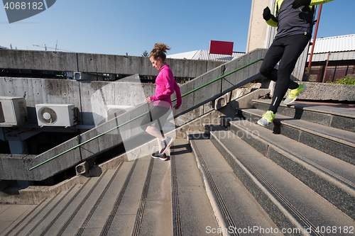 Image of young  couple jogging on steps