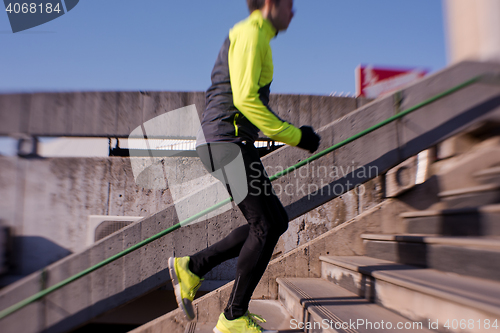 Image of man jogging on steps