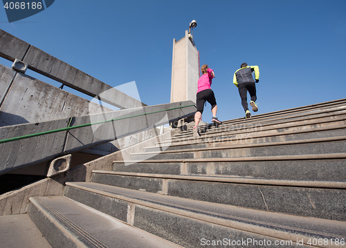 Image of young  couple jogging on steps