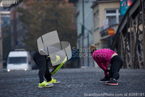 Image of couple warming up before jogging