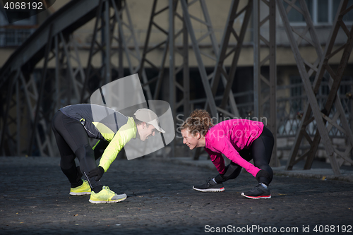 Image of couple warming up before jogging