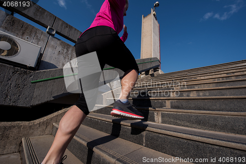 Image of woman jogging on  steps
