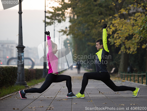 Image of couple warming up before jogging