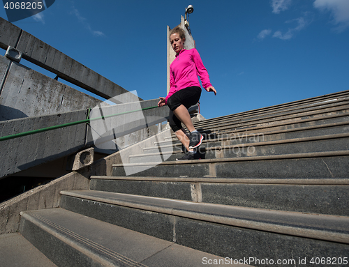 Image of woman jogging on  steps