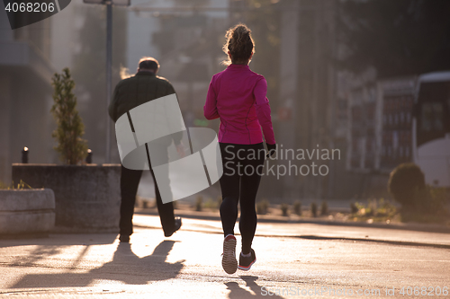 Image of sporty woman jogging on morning
