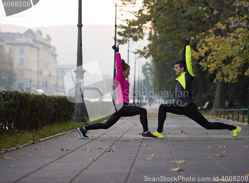 Image of couple warming up before jogging