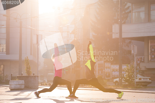 Image of couple warming up before jogging